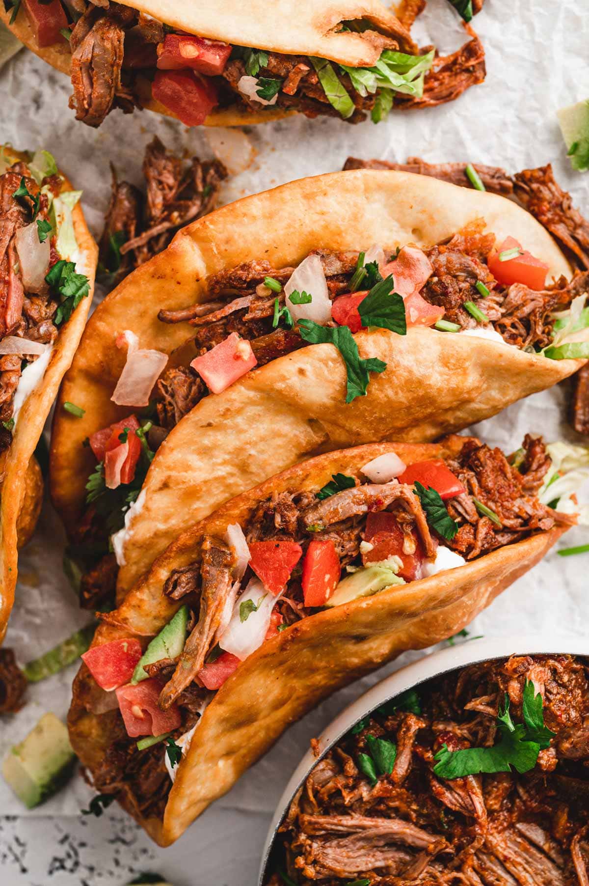 2 Tacos with shredded beef and pico de gallo.