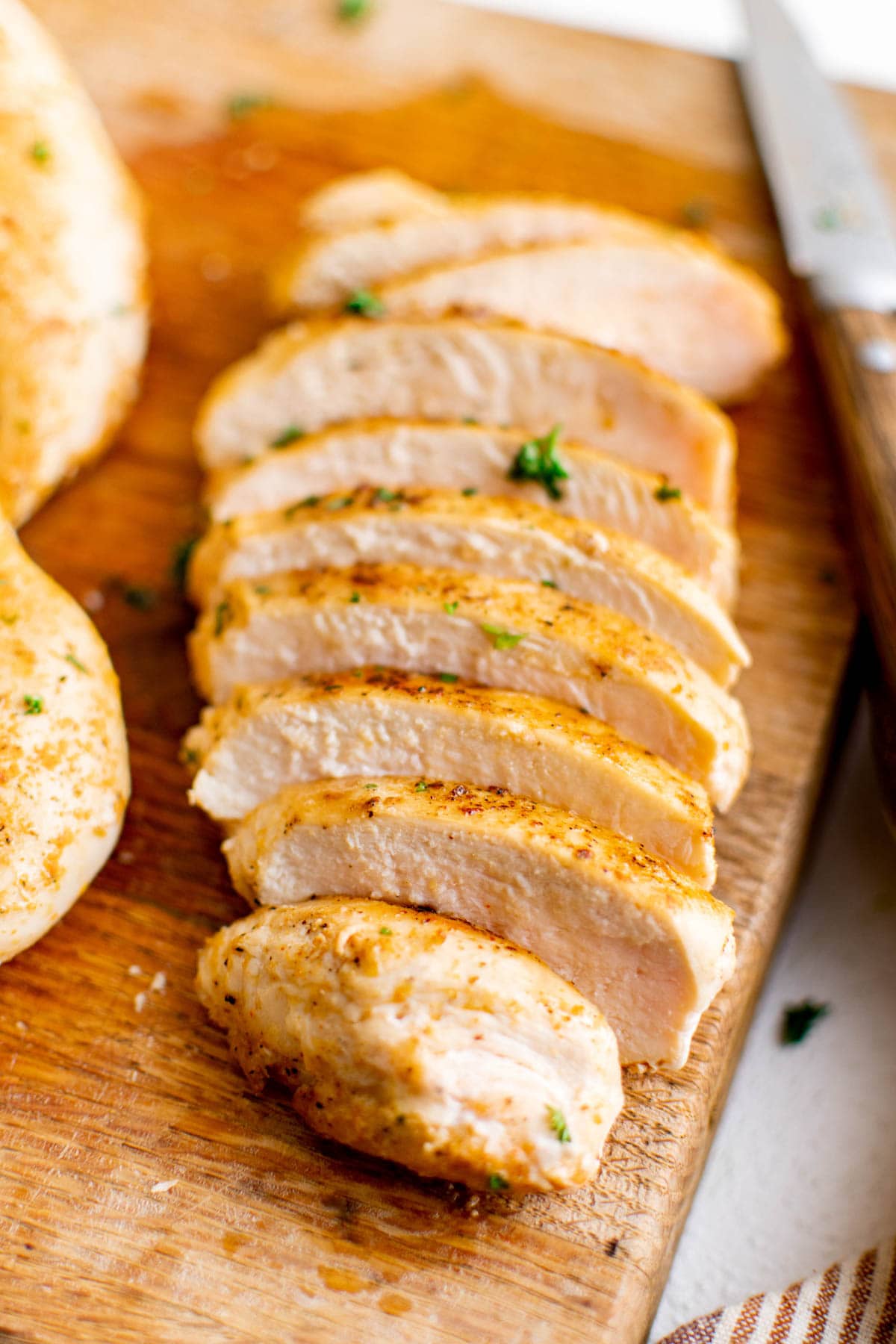 sliced chicken breast on a cutting boar.