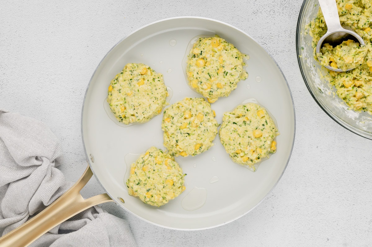 Fritters in a skillet before frying.