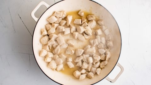 Diced chicken in a skillet.