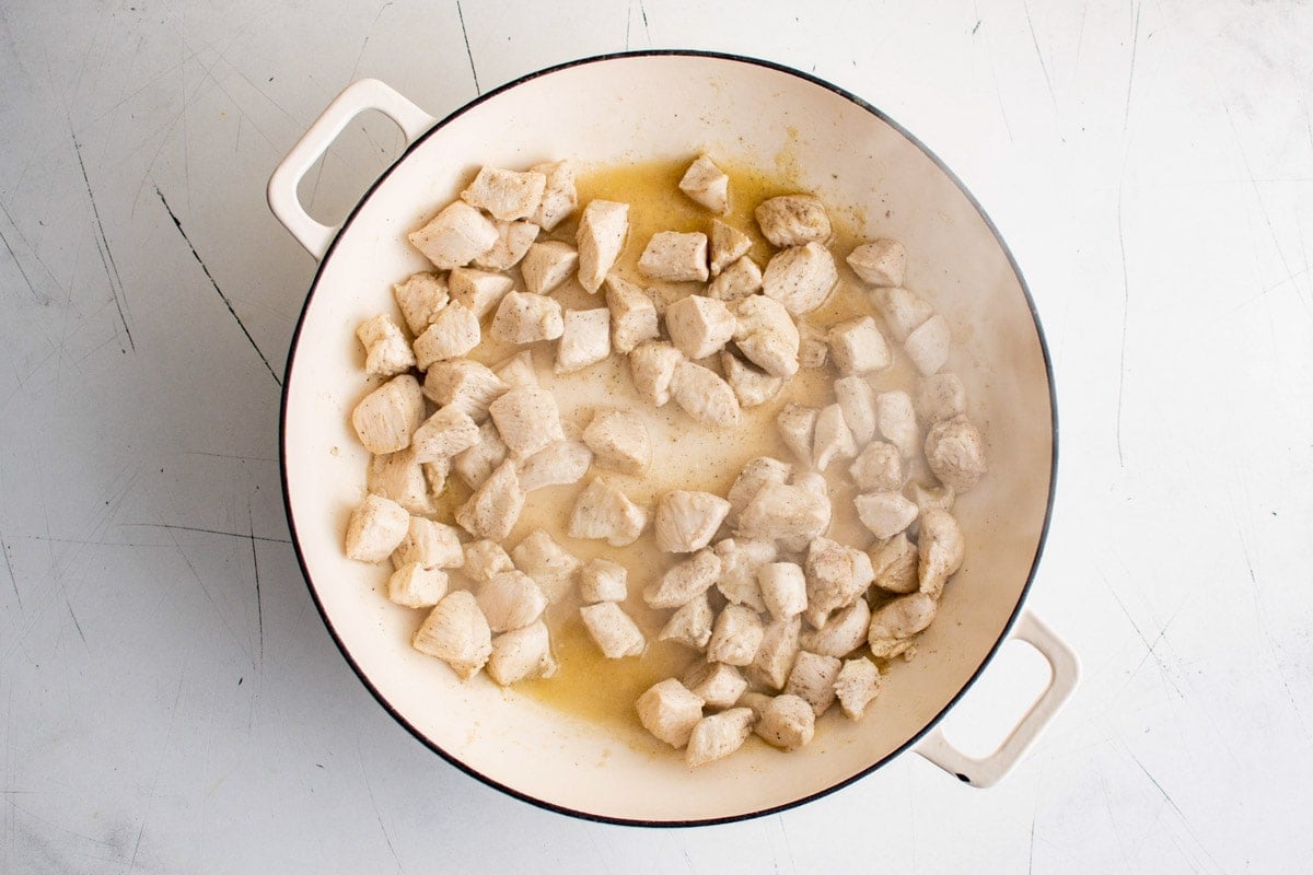 Diced chicken in a skillet.