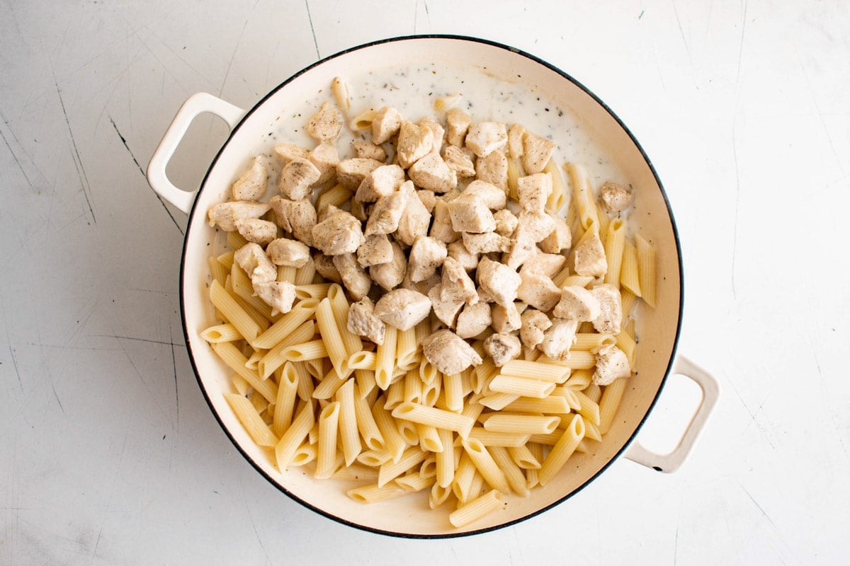 Penne pasta and diced chicken in a cream sauce.