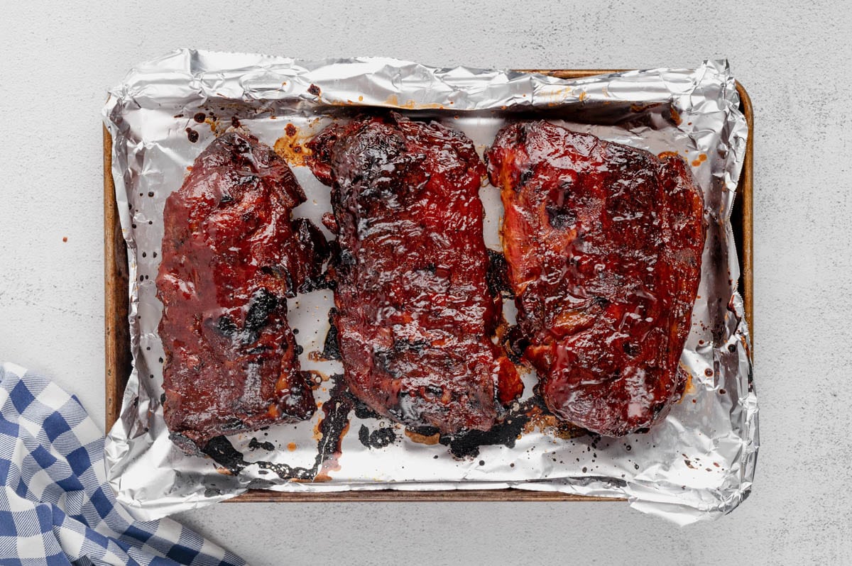 Broiled ribs on a baking sheet.