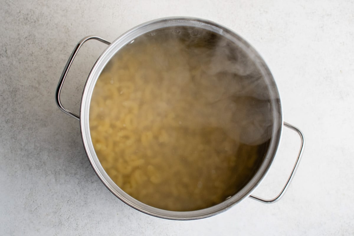 Boiling macaroni in a large pot.