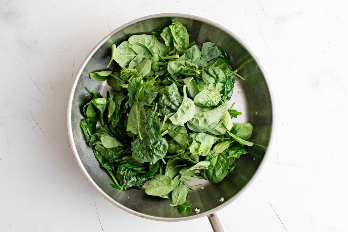 Baby spinach in a skillet.