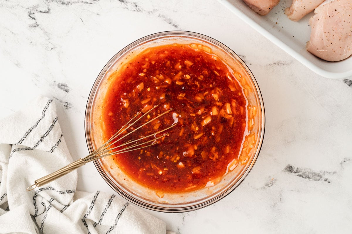 Apricot preserves sauce in a glass dish.