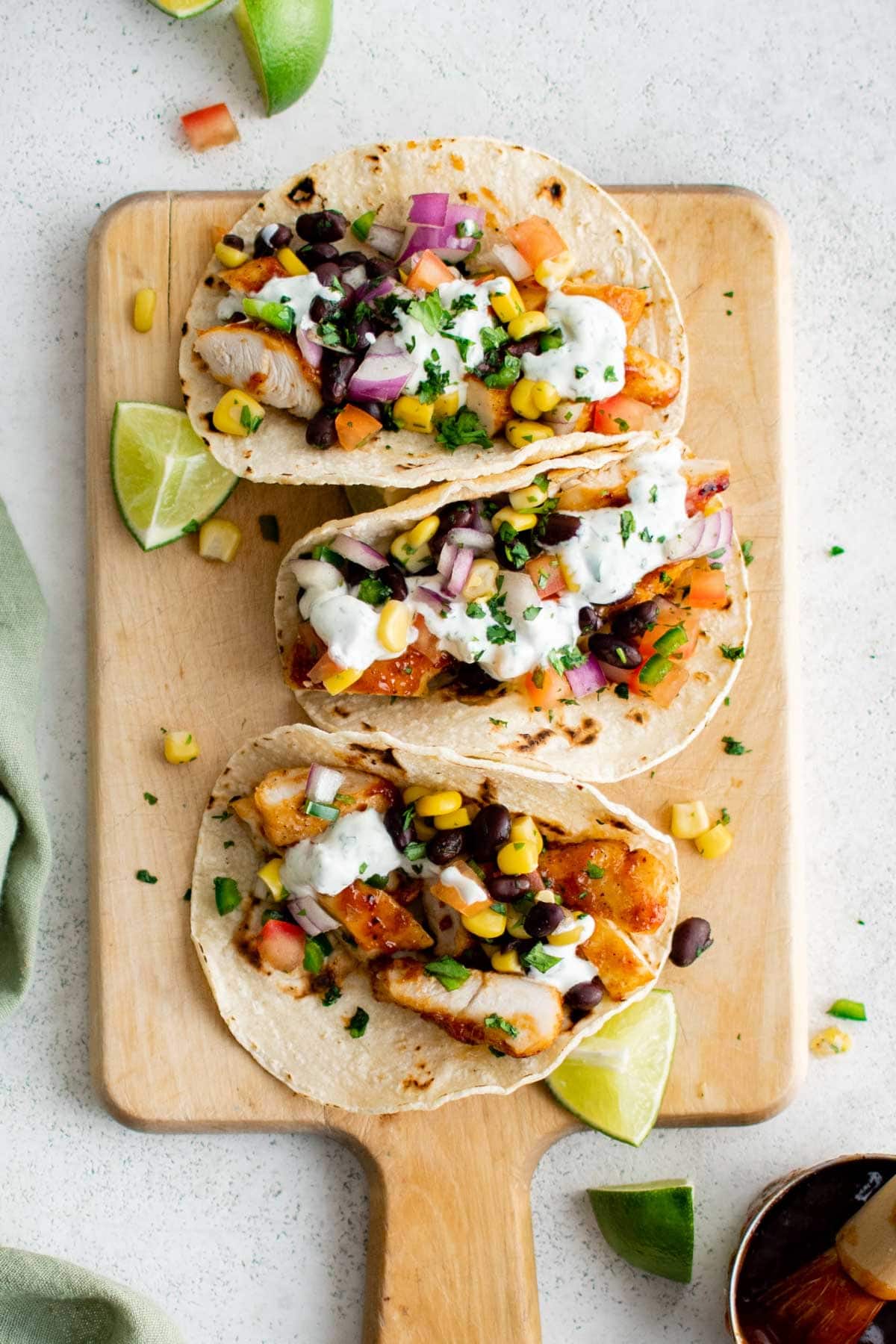 Three tacos with chicken and black bean salsa.