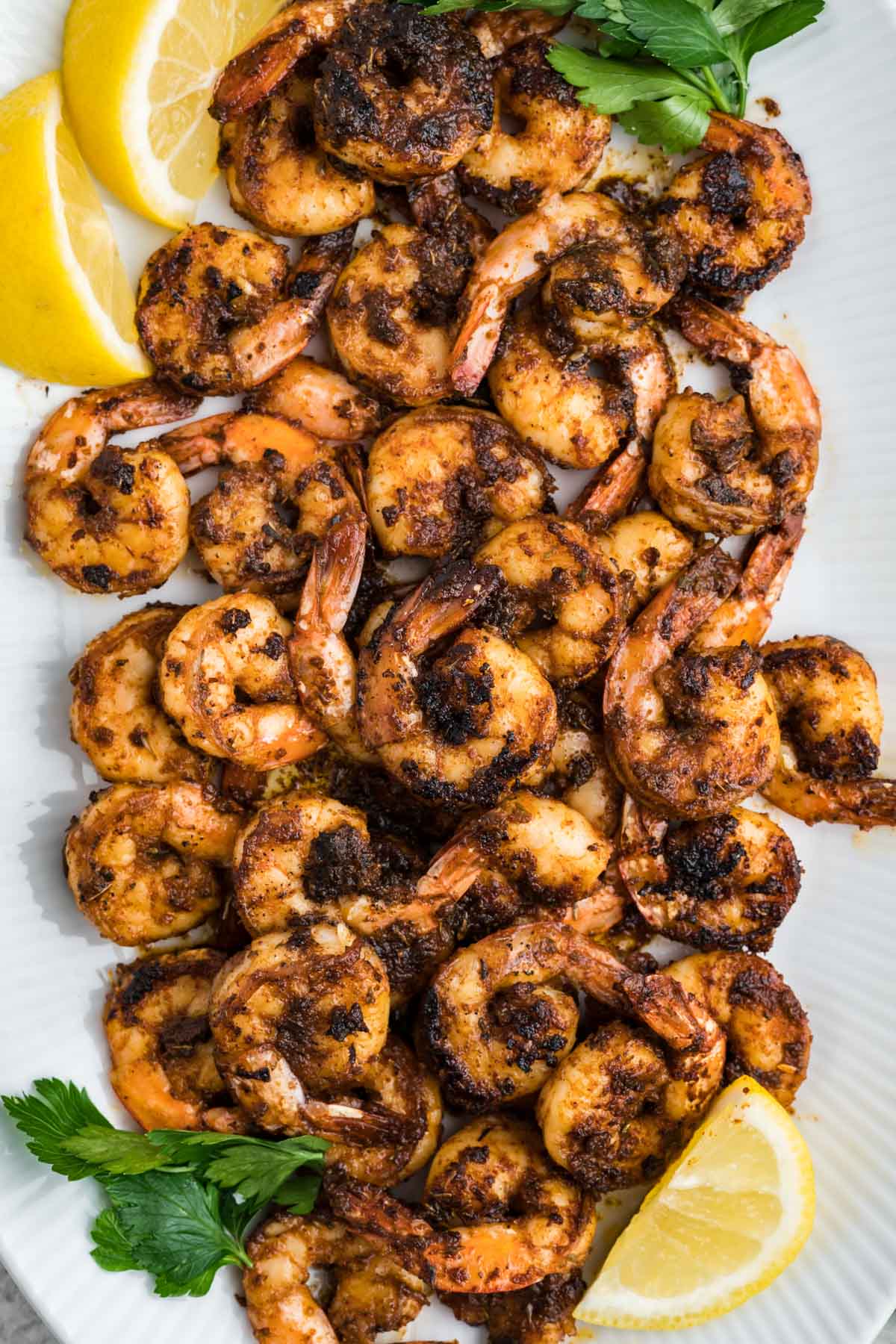 Blackened shrimp, in a pile on a serving platter.