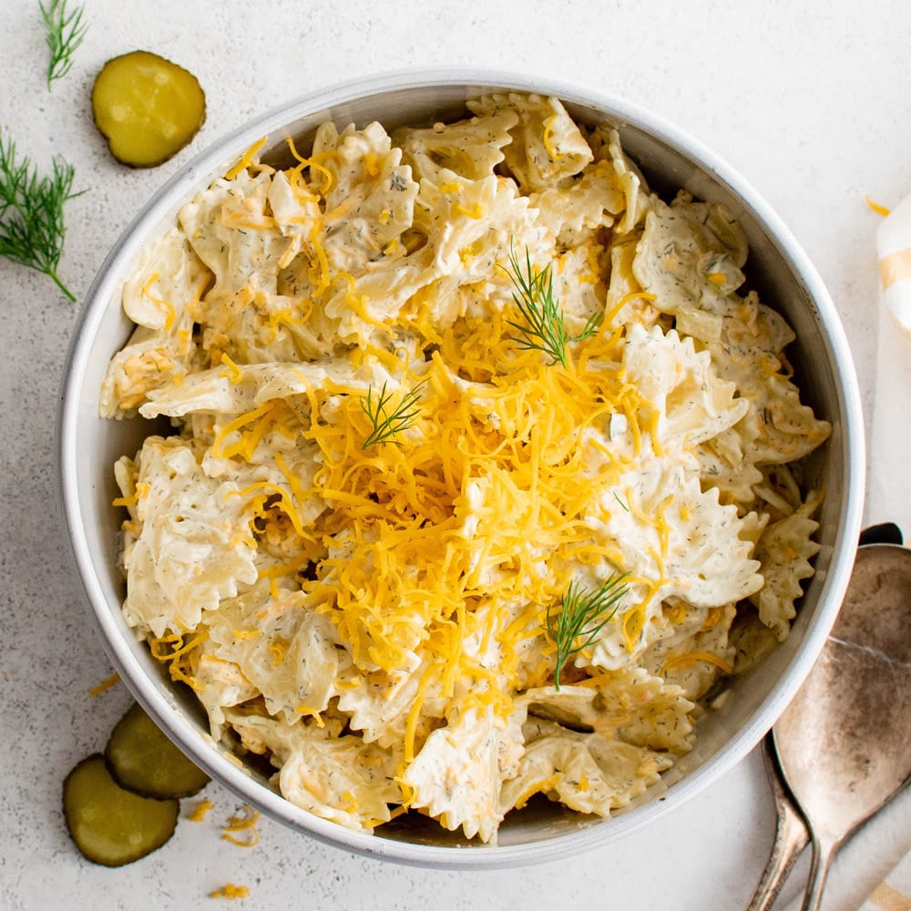 Dill pickle pasta salad in a white serving bowl.