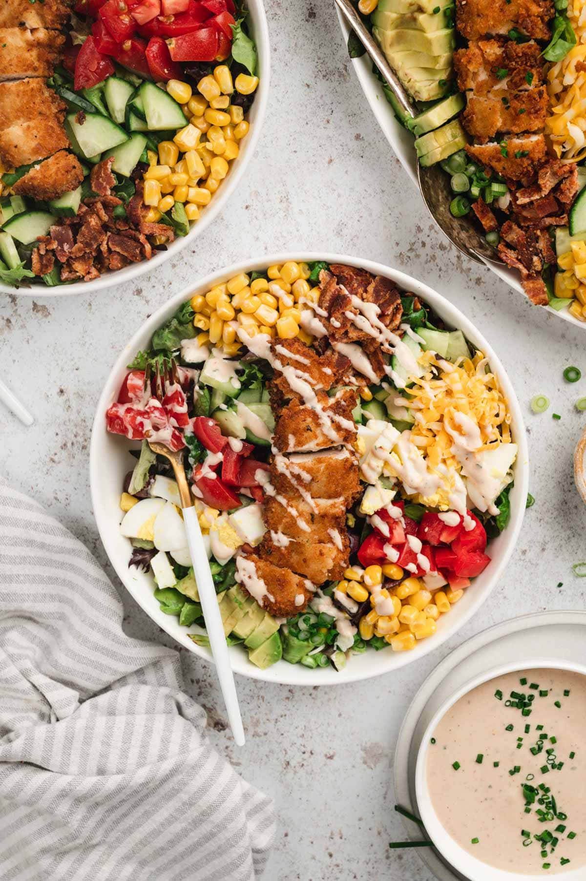 Crispy Chicken Salad in a white bowl with a fork.