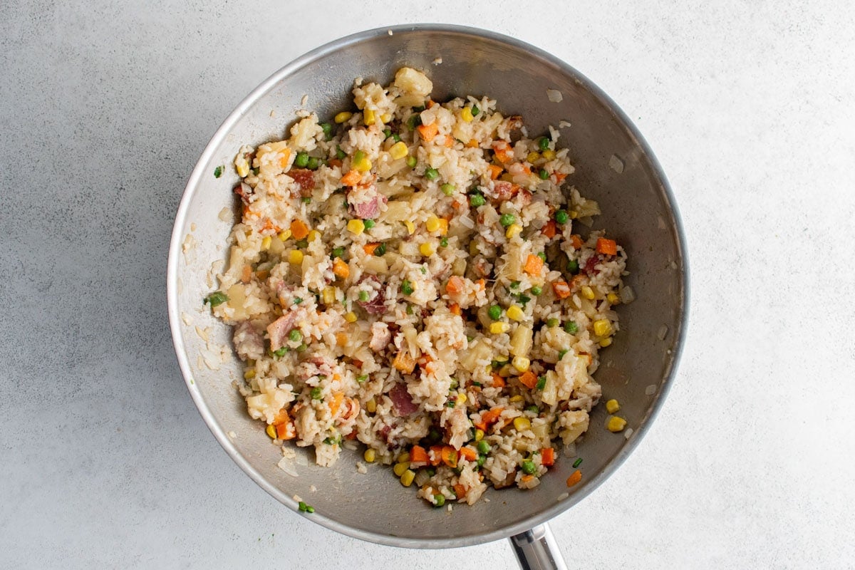 Bacon pineapple fried rice in a wok.