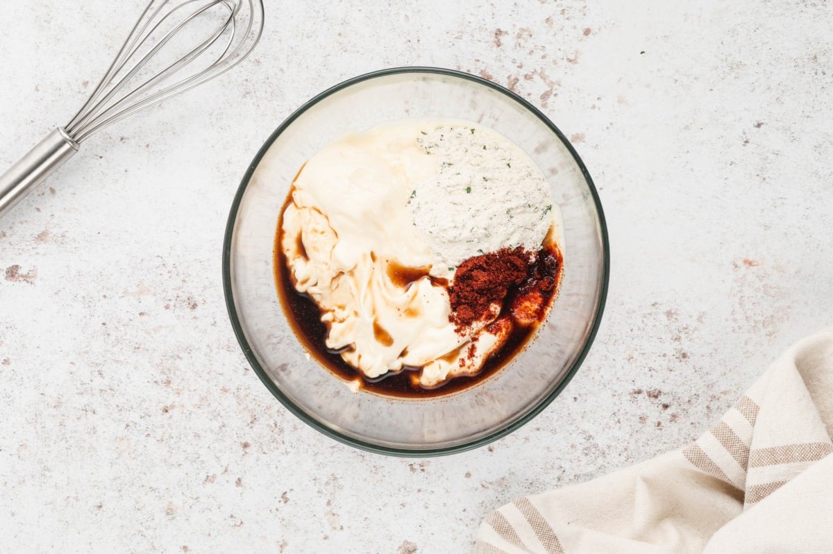 Mayo, paprika, worcestershire sauce and ranch seasoning in a clear glass bowl.