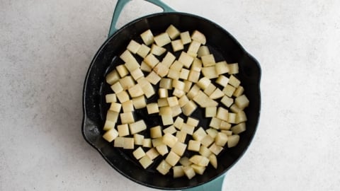 Diced potatoes in a large skillet.
