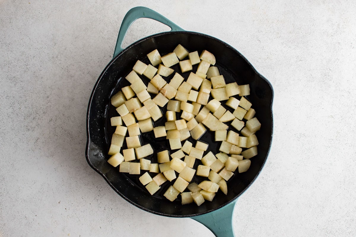 Diced potatoes in a large skillet.