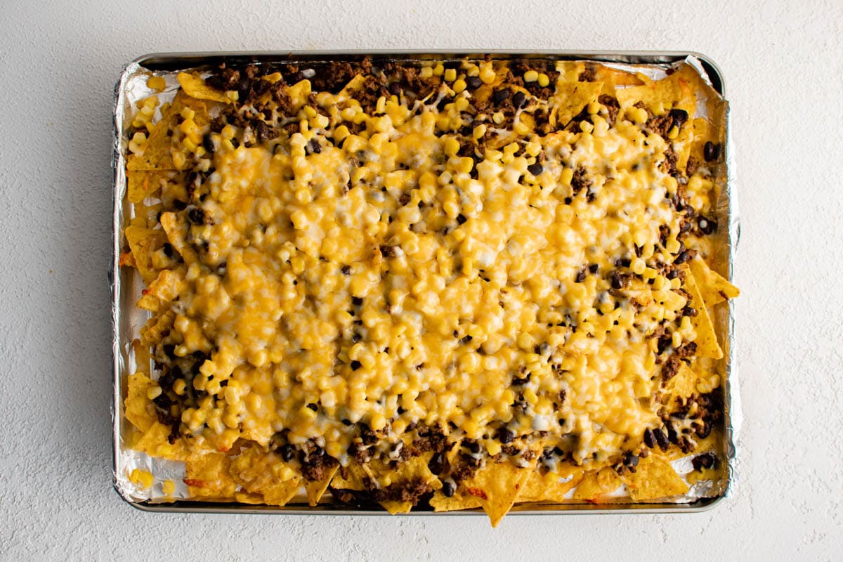 Melted cheese layered over ground beef and tortilla chips.