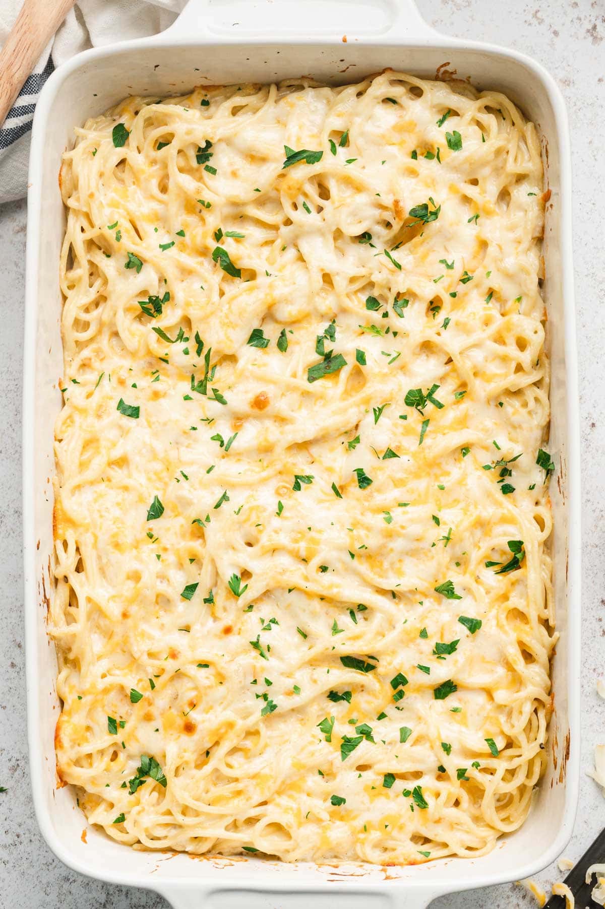 Spaghetti mac and cheese casserole in a white baking dish.