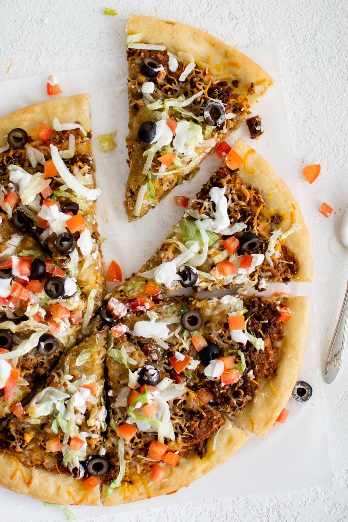 Taco pizza, sliced.