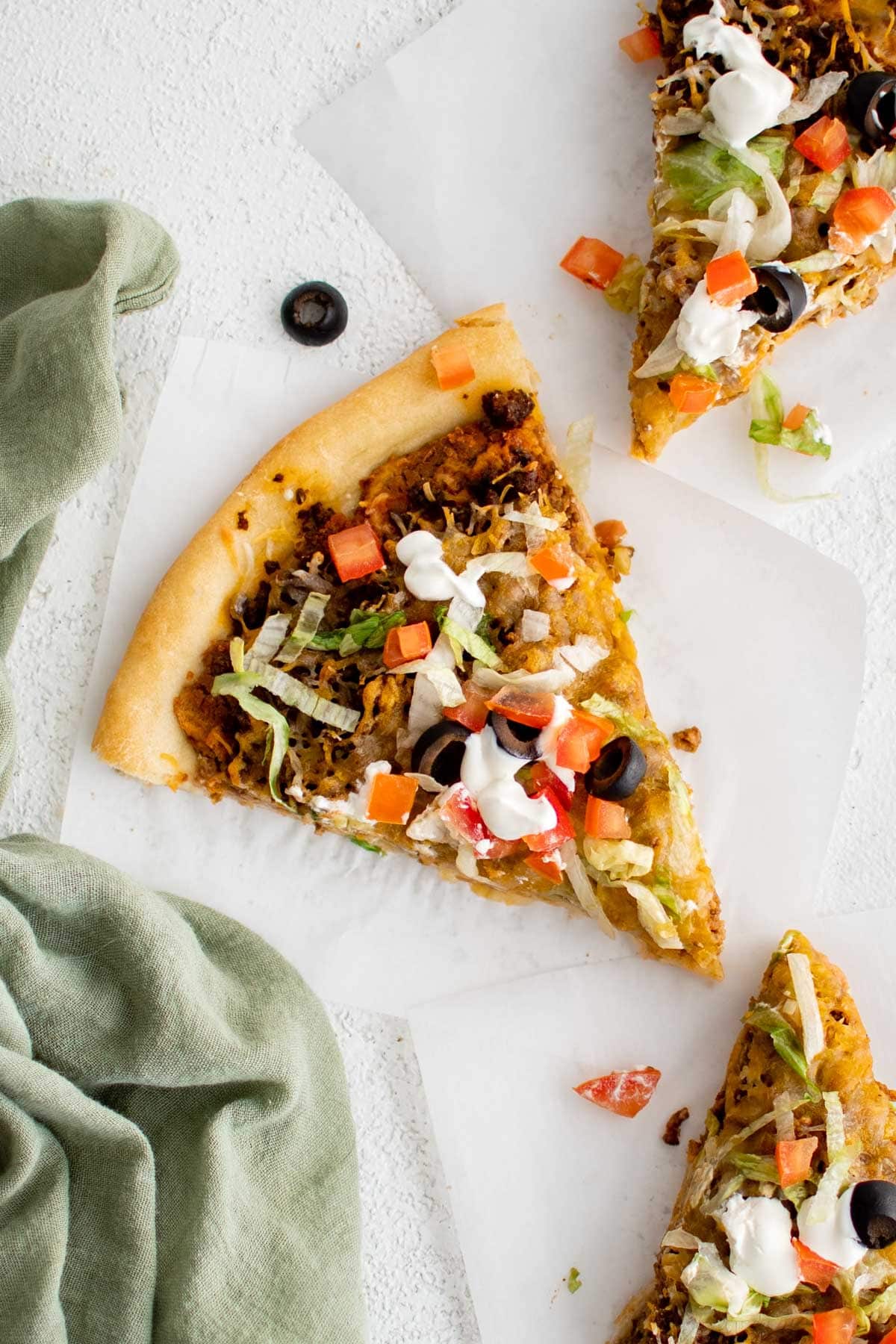 Pizza slice with taco toppings.