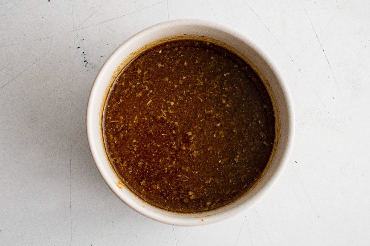 Olive oil and seasonings in a small bowl.