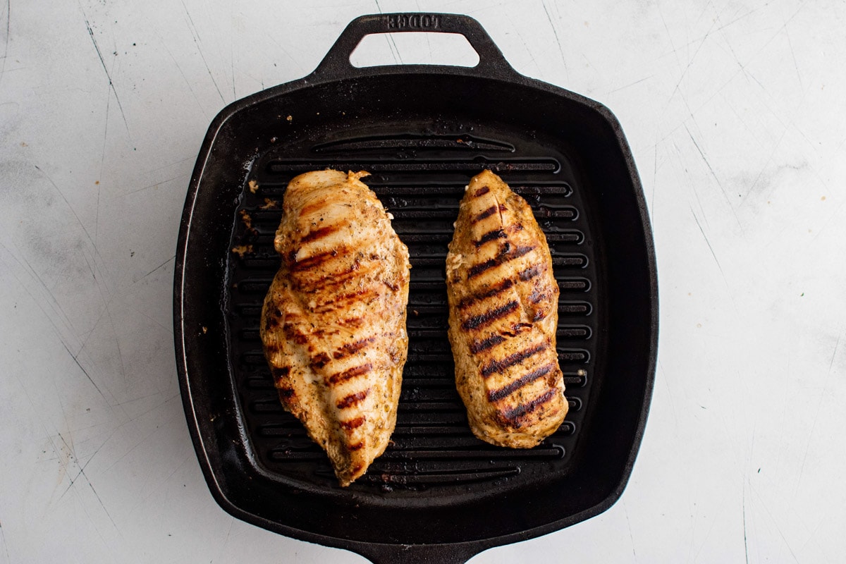 Grilled chicken breasts in a grill pan.