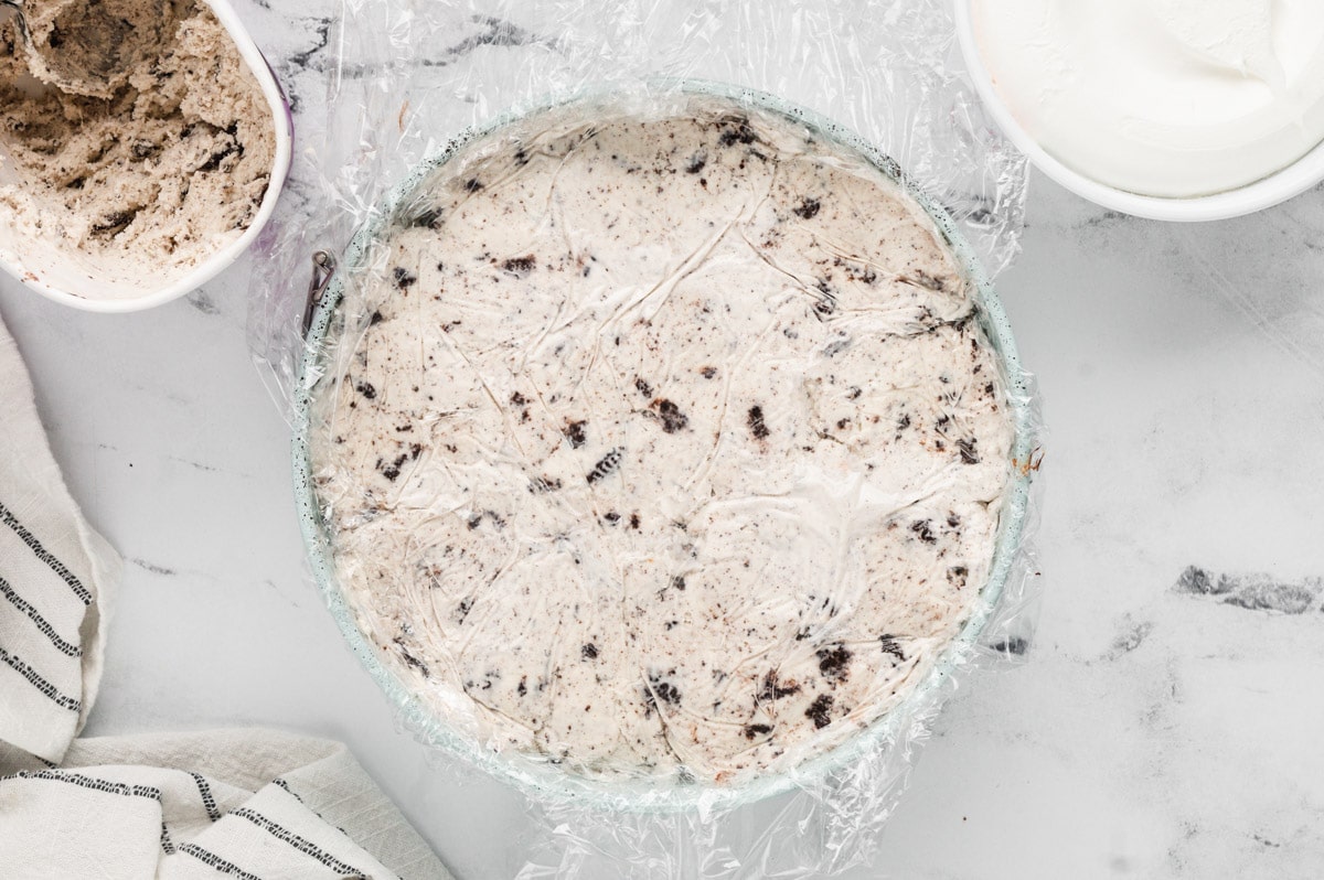 Smooth cookies and cream ice cream in a round cake pan.