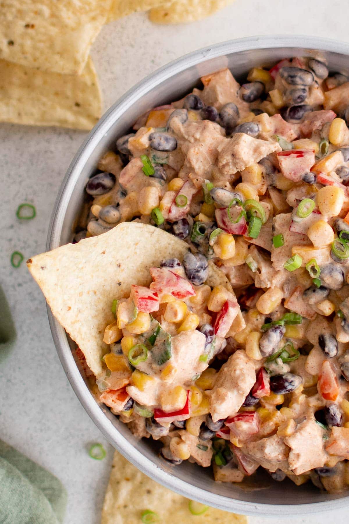 Southwest chicken salad with veggies and black beans and a tortilla chip.