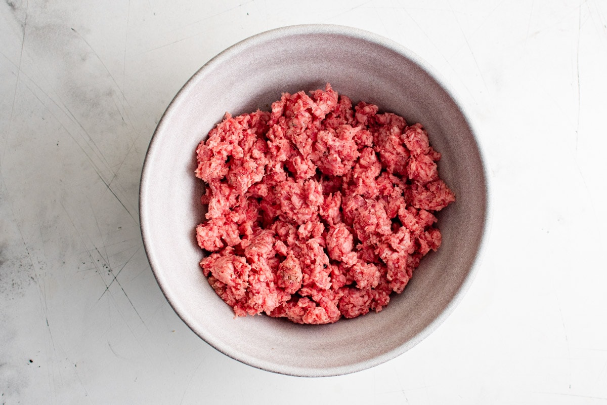 Ground beef in a large mixing bowl.