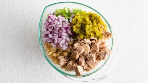 Tuna, relish, onions and celery in a glass dish.