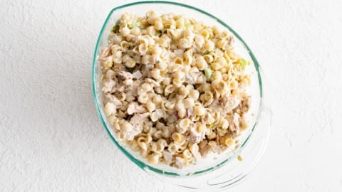 Creamy pasta salad in a glass dish.