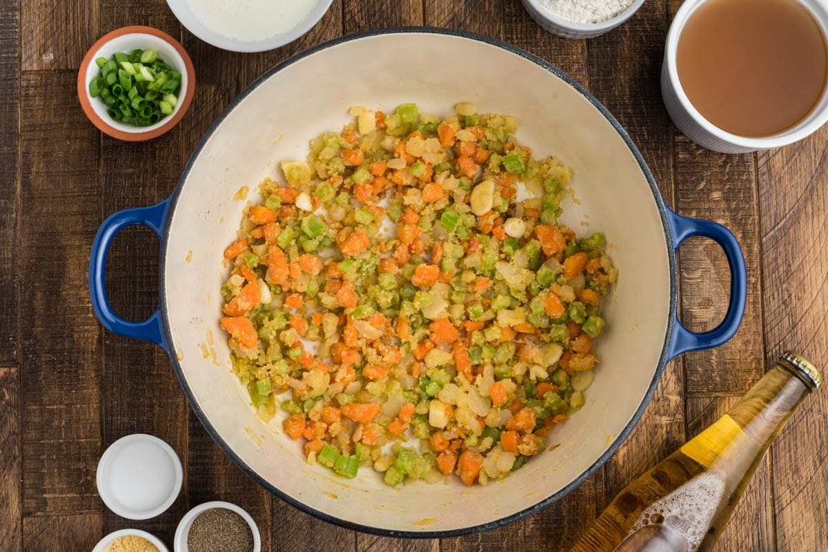 Carrots, onion and celery cooking in a large pot.