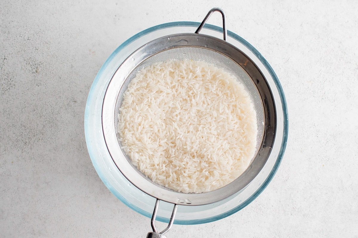 Mesh sieve with wet rice.