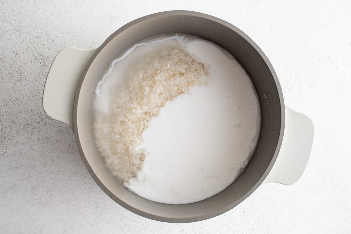 Rice, water and coconut milk in a saucepan.