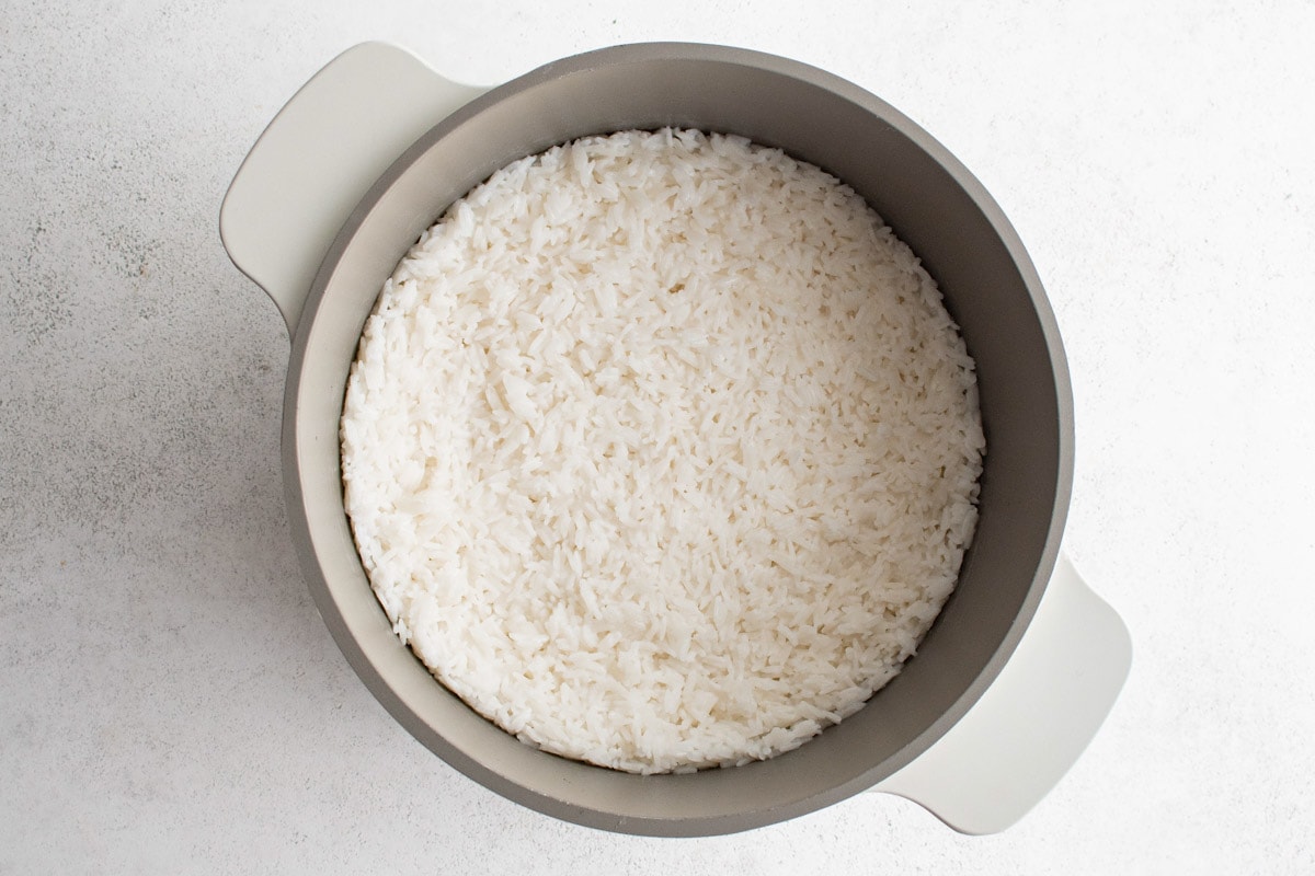 Rice finished cooking in a saucepan. 