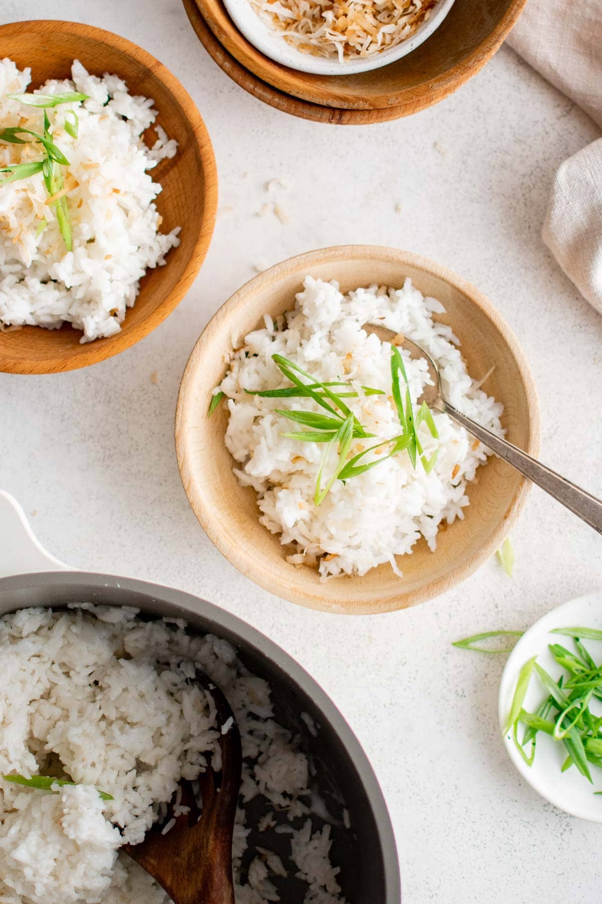 Plates and bowl filled with coconut rice.