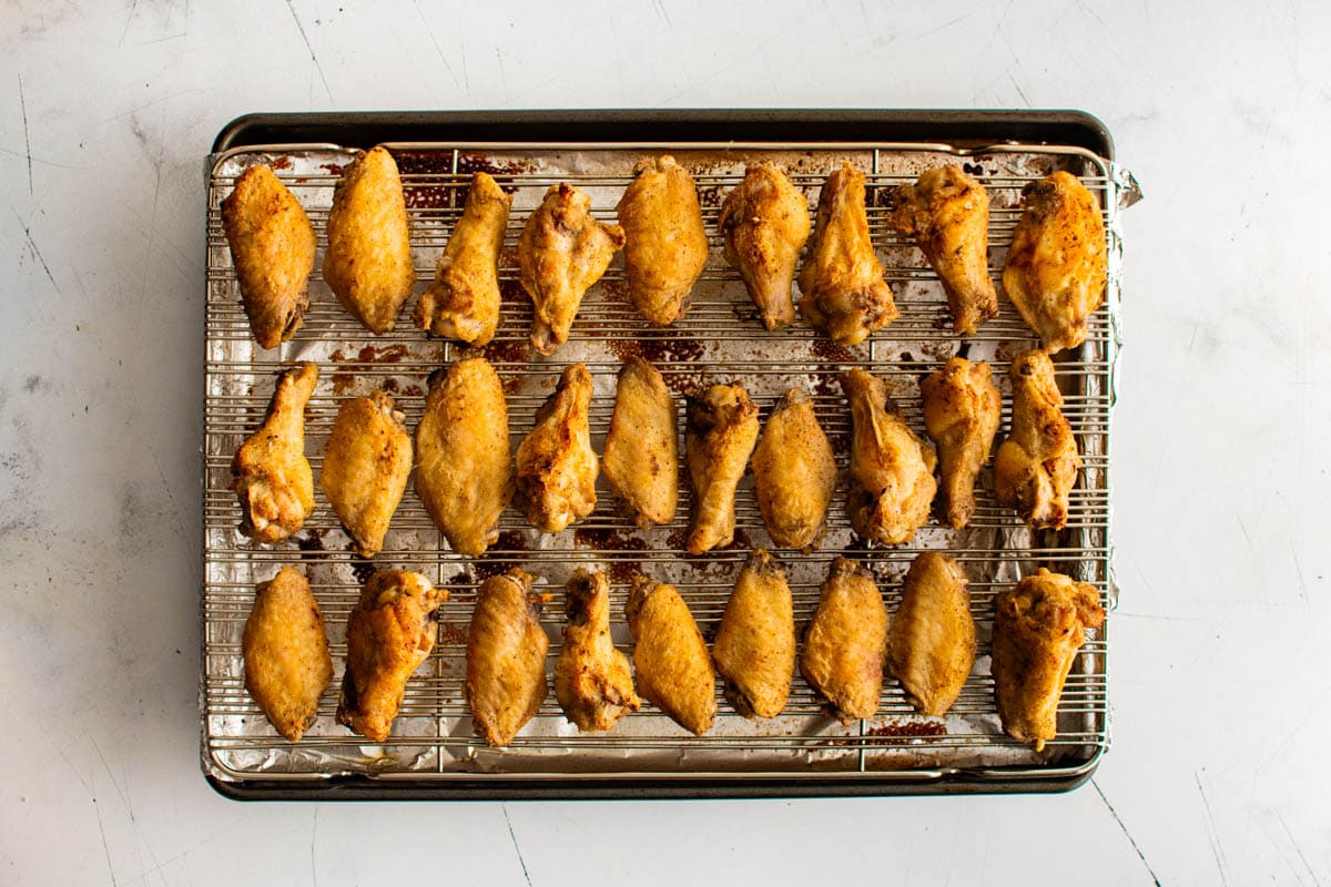 baked crispy chicken wings on a baking rack.