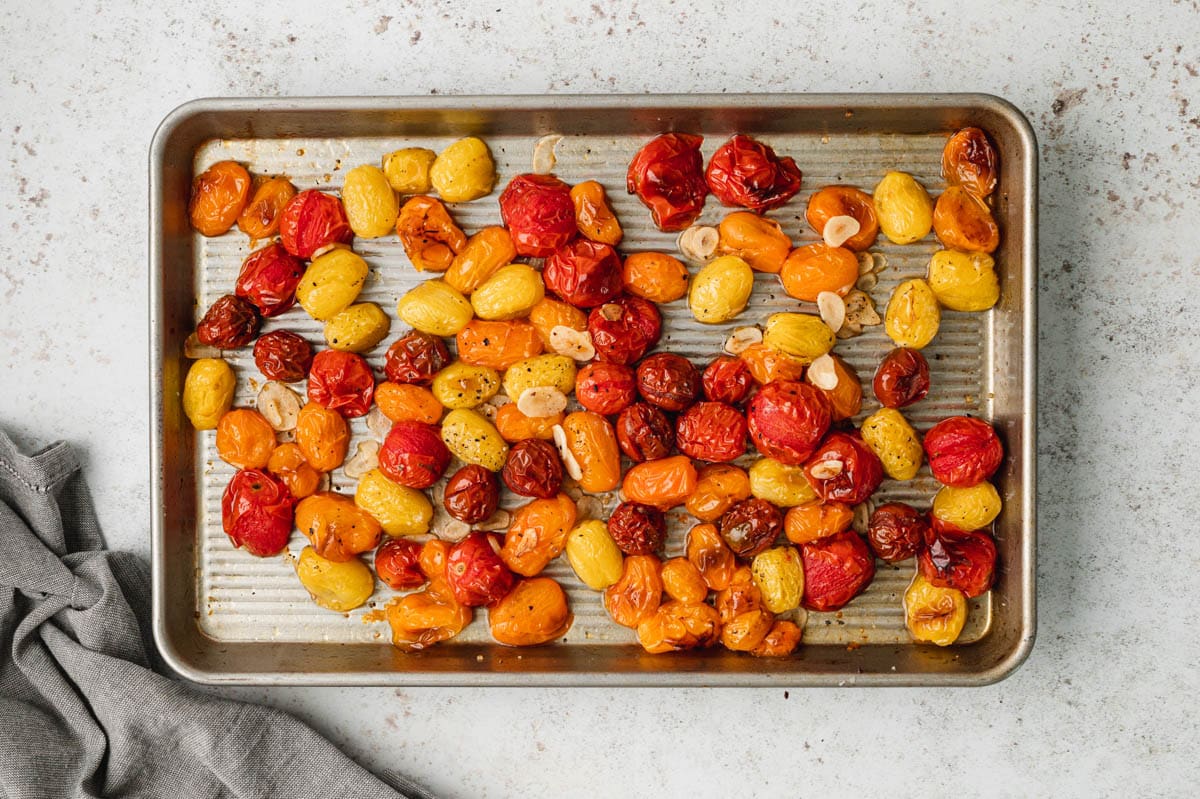 Roasted cherry tomatoes on a baking sheet.