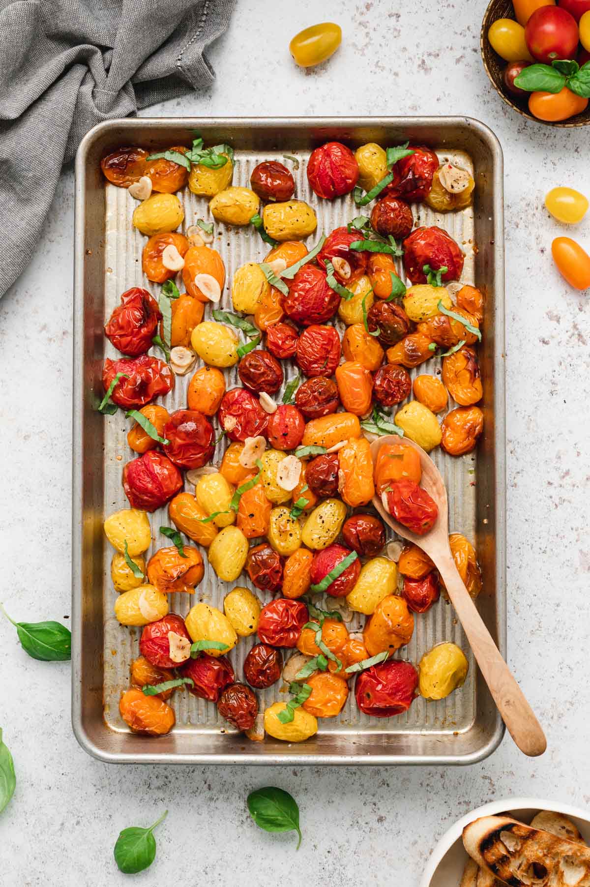 Roasted Cherry Tomatoes are tossed with garlic and fresh herbs for an easy and flavorful way to use fresh summer produce.