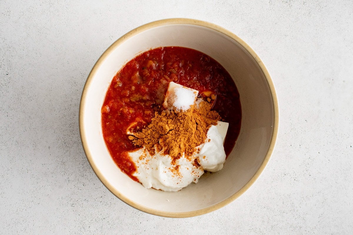 salsa, cream cheese, plain yogurt and taco seasoning in a bowl.