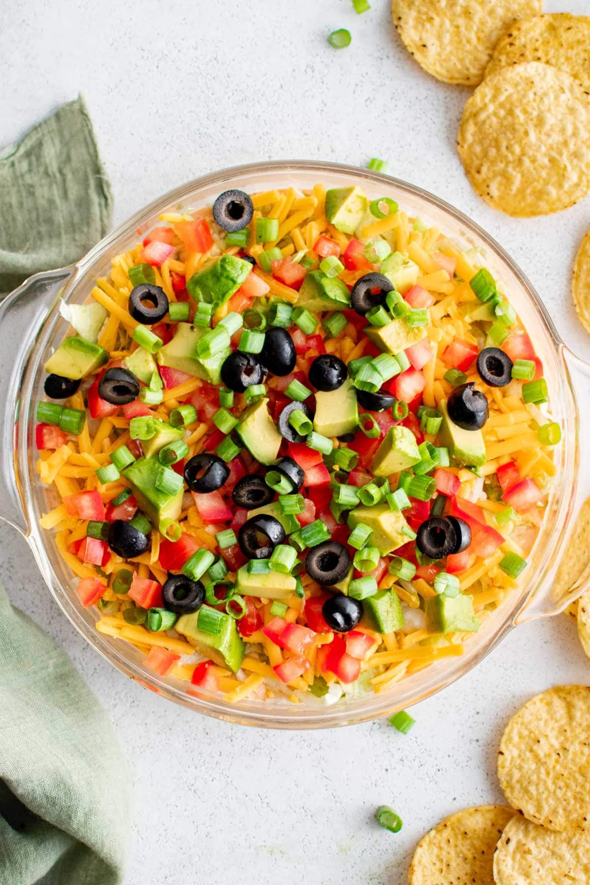 Round dish with layered taco dip.