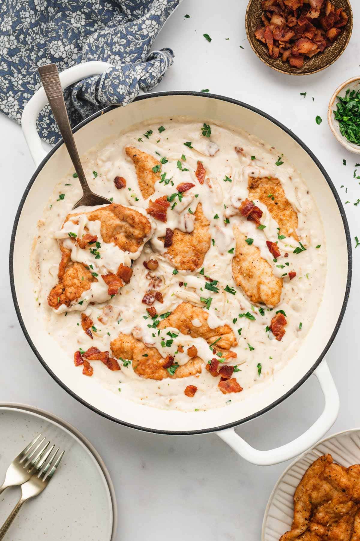 Chicken cutlets, fried and then smothered in a skillet of gravy.