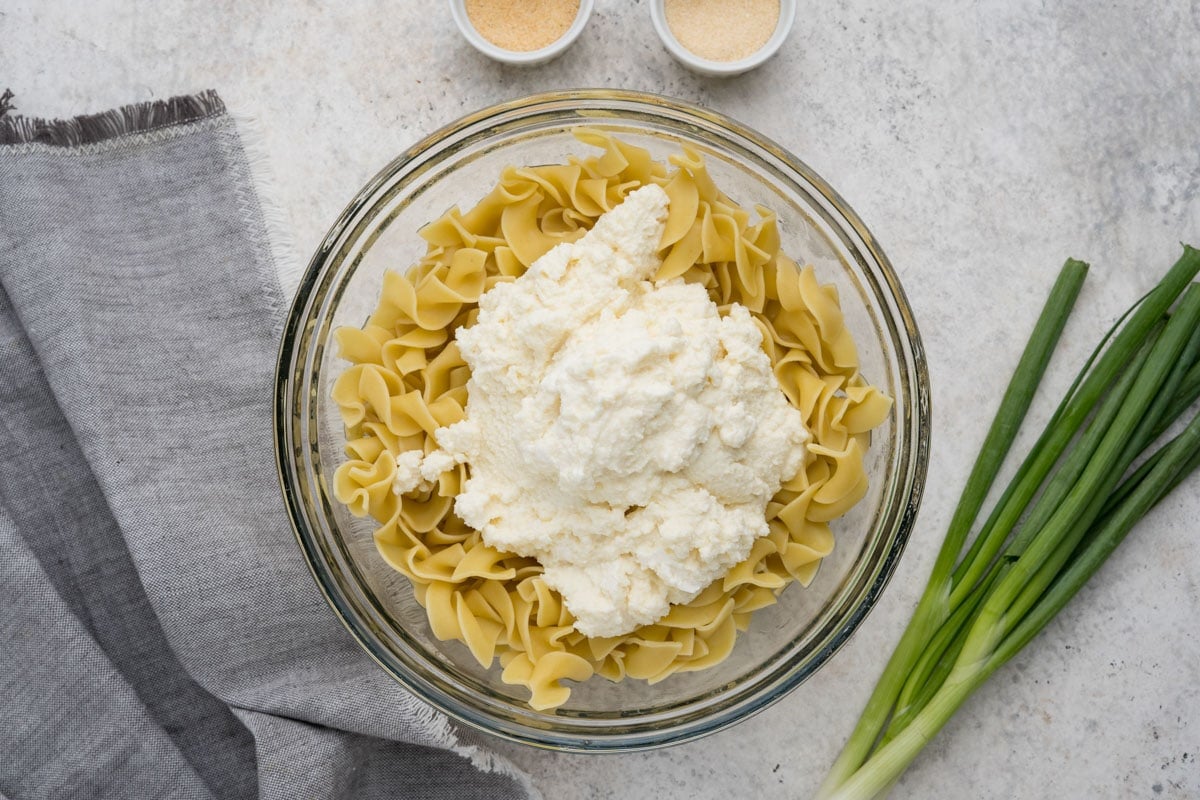 Egg noodles in a bowl with sour cream.