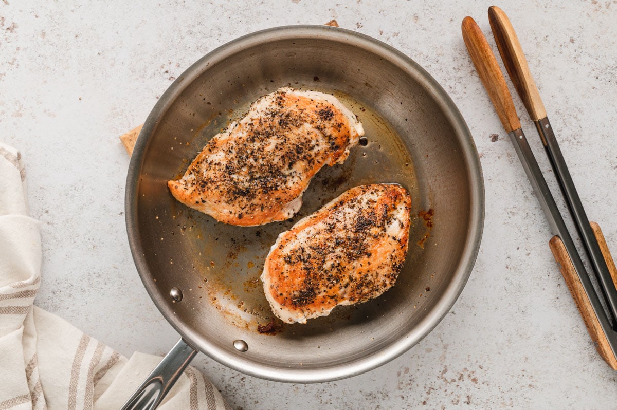 2 Pan seared chicken breasts in a metal skillet