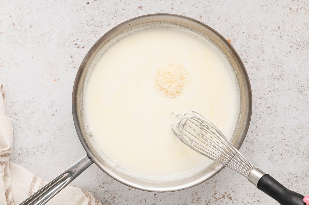 Butter and cream whisked together in a skillet.