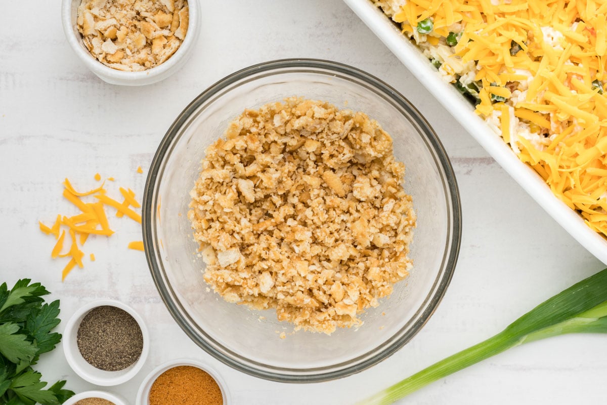 Crushed crackers in a small bowl and mixed with melted butter.