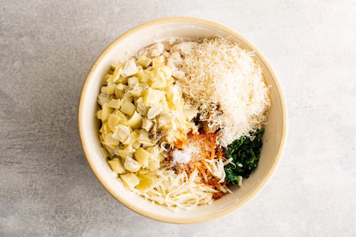 Bowl with artichokes, spinach, and cheeses.
