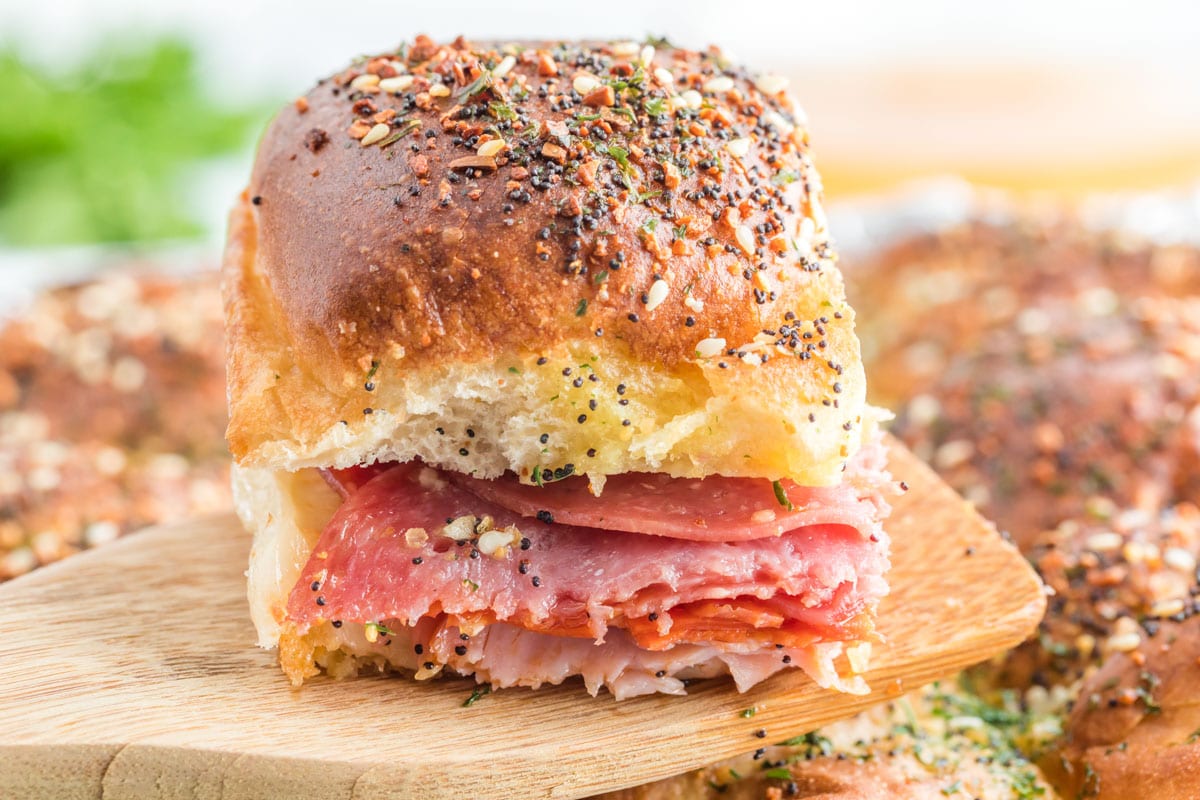 baked italian slider on a wooden spatula