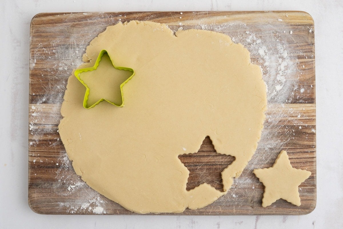 Rolled out dough with a star cookie cutter.