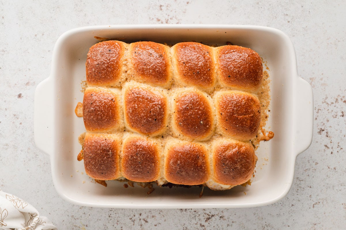 Baked turkey sliders in a white baking dish.