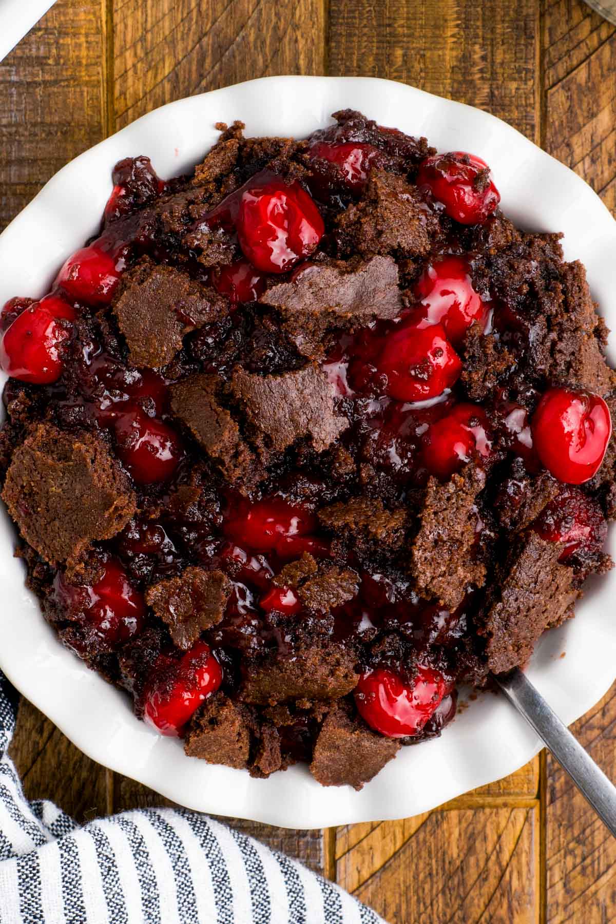 Shallow serving bowl with chocolate cake and cherry pie filling.