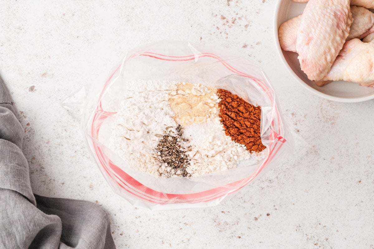 Mix of seasonings and flour and baking powder in a plastic bag.